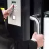 Man entering code in keypad to unlock security door